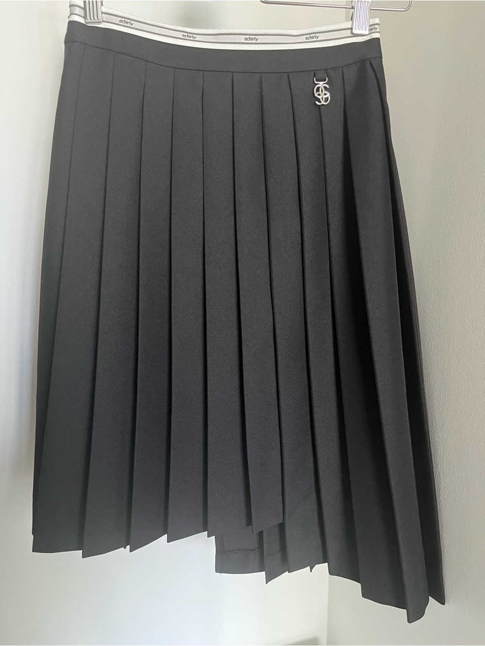 Black Pleated Midi Skirt with Subtle Logo Charm